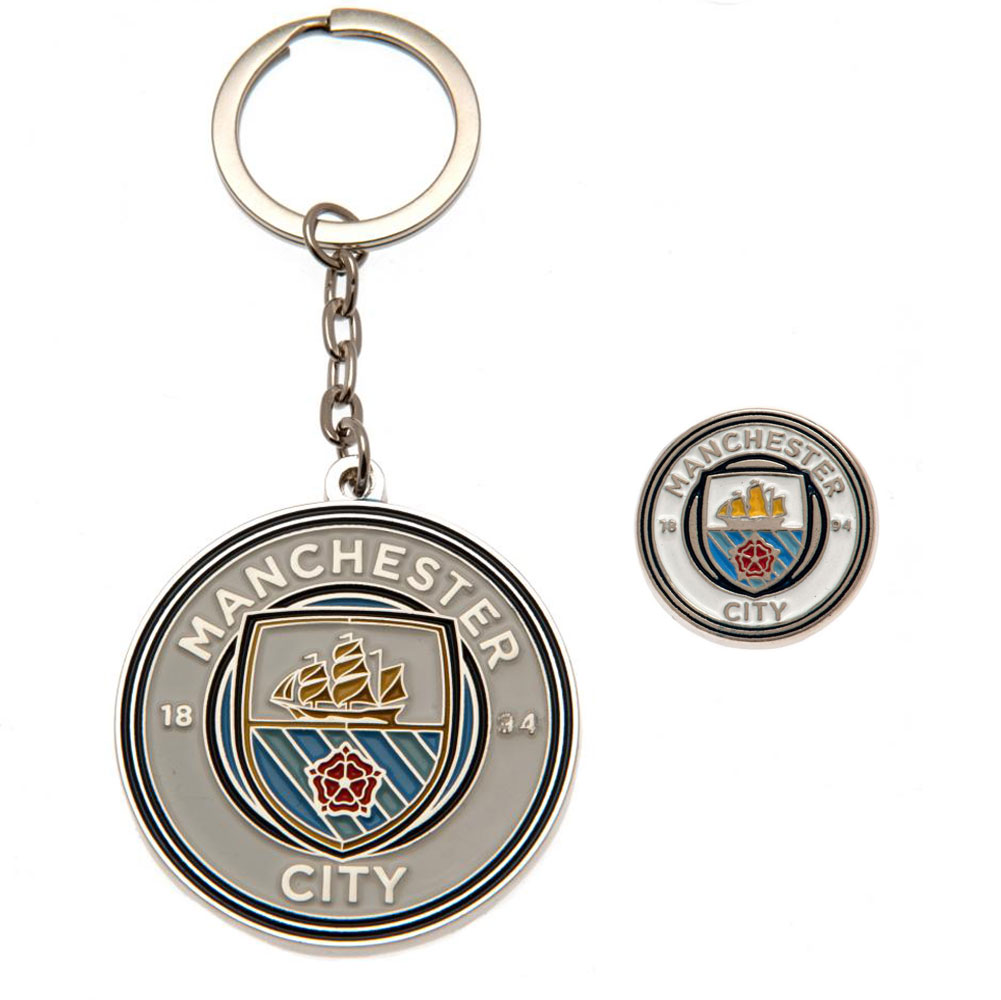 Manchester City FC crest shaped metal keyring and crest pin badge set on a backing card
