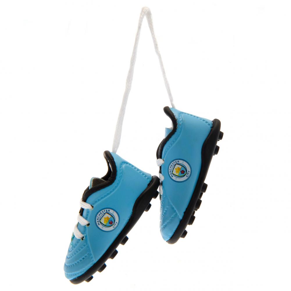 Pair of sky blue Manchester City mini football boots with laces and a printed City crest on each side