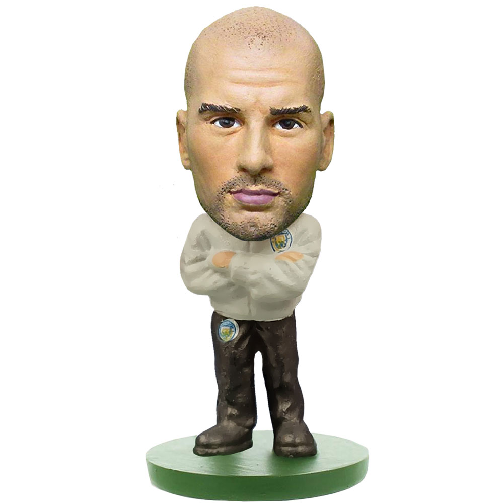 Guardiola SoccerStarz figure in a managers suit standing on a green base in a blister pack